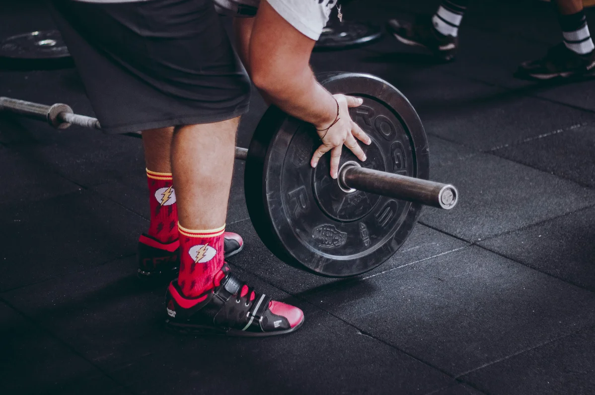 Weightlifter using 35-pound plates during training session Weightlifter using 35-pound plates during training session
