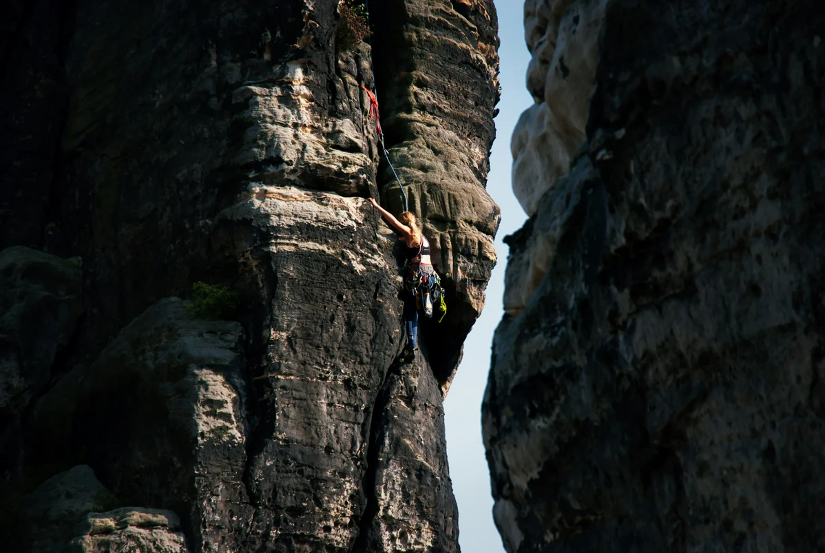 A climber practicing drills on rocky terrain to enhance climbing skills A climber practicing drills on rocky terrain to enhance climbing skills