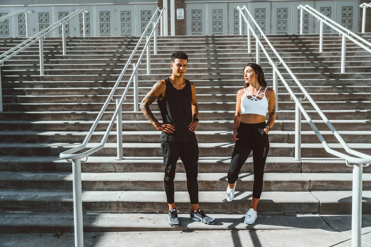 Couple celebrating their fitness achievement at a Hyrox event Couple celebrating their fitness achievement at a Hyrox event