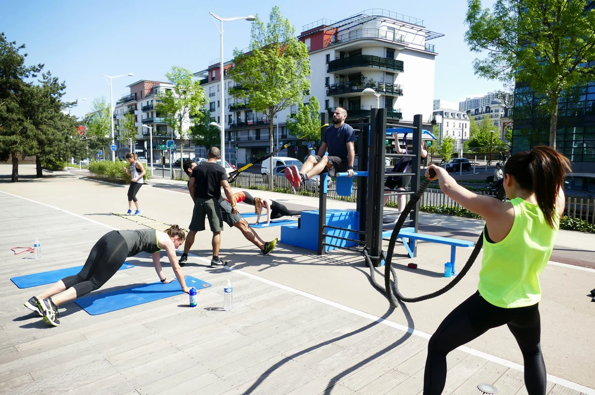 Group of people exercising together in a park, representing social fitness Group of people exercising together in a park, representing social fitness