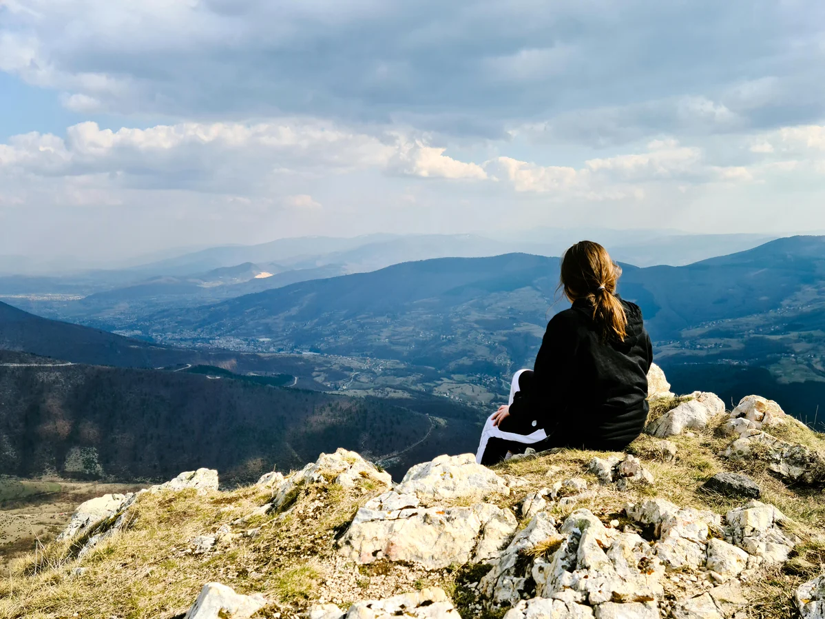 Hiker enjoying breathtaking views while exploring a geopark trail Hiker enjoying breathtaking views while exploring a geopark trail