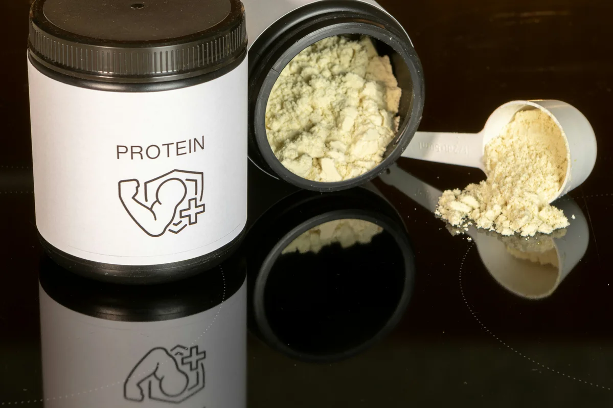Various protein sources displayed on a table including meats, legumes, and dairy Various protein sources displayed on a table including meats, legumes, and dairy