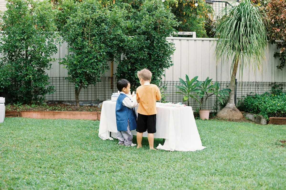 A camping tent being washed in a backyard with a hose