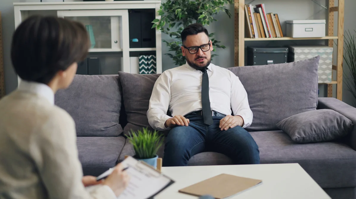 A man talking to a therapist about mental health A man talking to a therapist about mental health