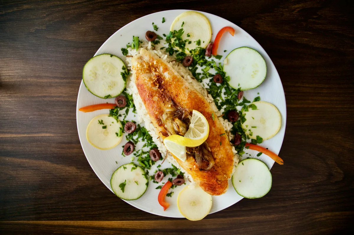 A plate featuring Mediterranean diet ingredients like olive oil, vegetables, and whole grains A plate featuring Mediterranean diet ingredients like olive oil, vegetables, and whole grains