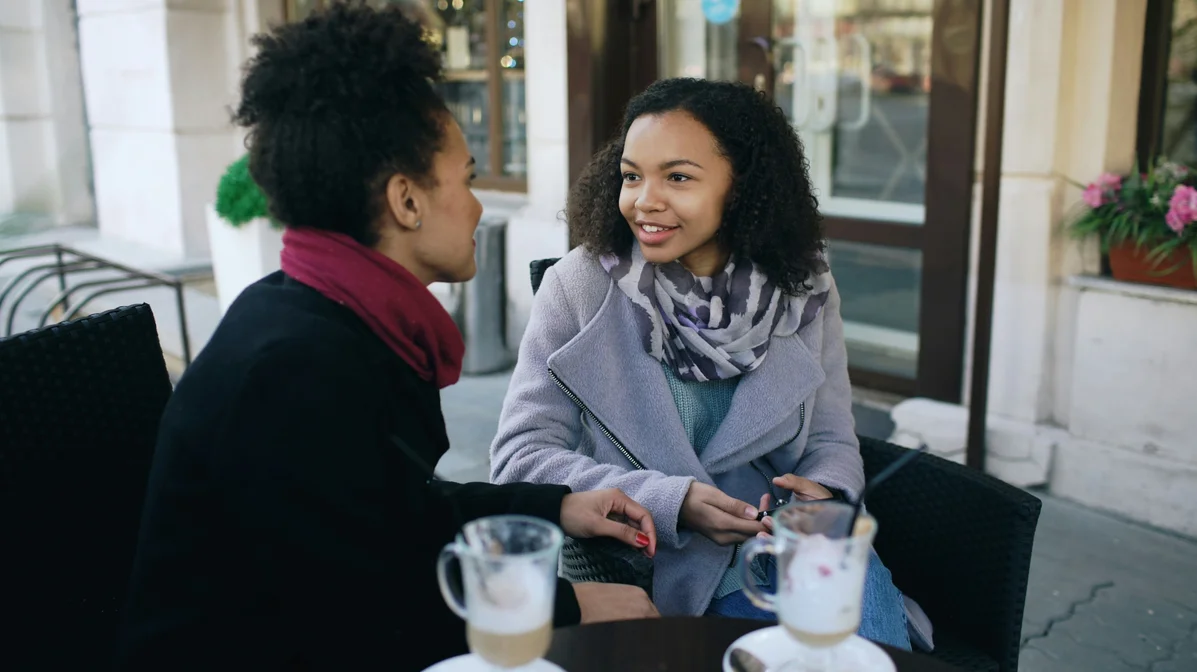 A couple sitting together and talking over coffee A couple sitting together and talking over coffee