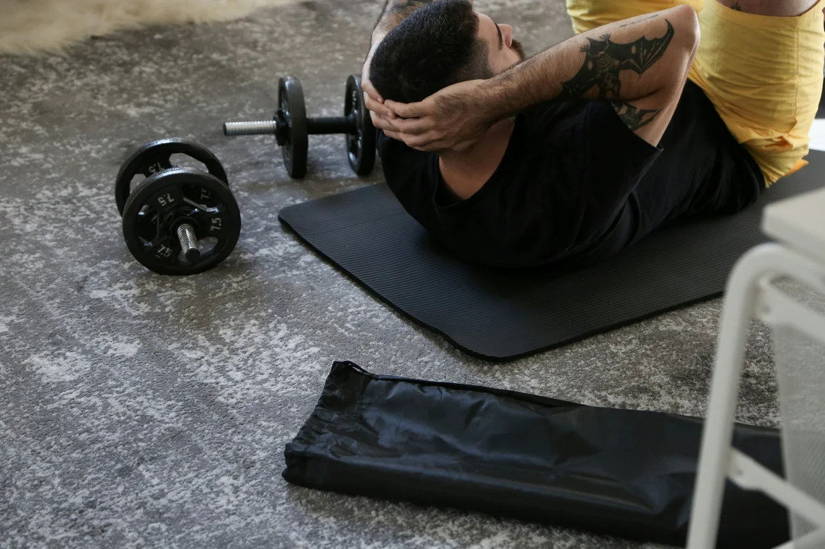 Weights and yoga equipment on a gym floor, showing tools for exercise during perimenopause