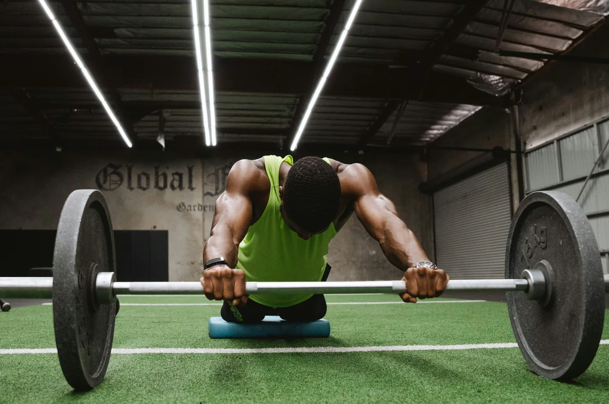 A person performing a barbell bent-over row with a pronated grip A person performing a barbell bent-over row with a pronated grip