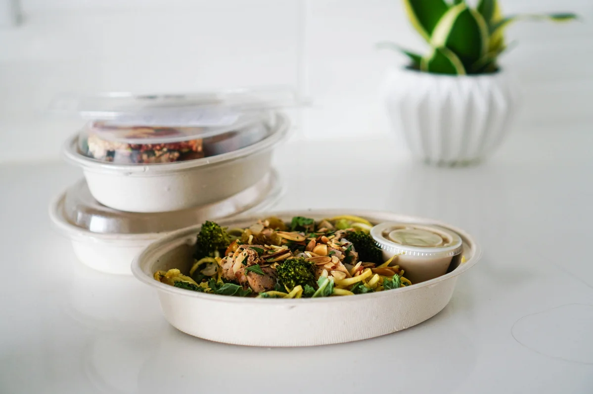 A meal prep container filled with protein-rich foods like chicken, beans, and vegetables