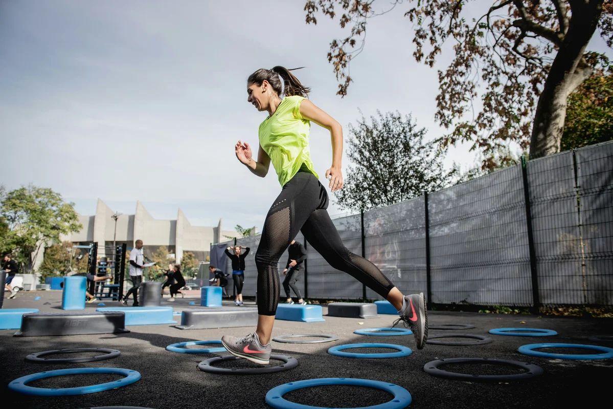 Woman engaging in a cardio workout outdoors to compare with strength training